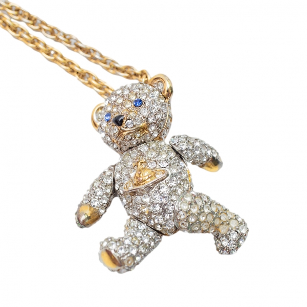 A Vivienne Westwood articulated Teddy bear pendant and chain, with pouch,  (area of glue on the back